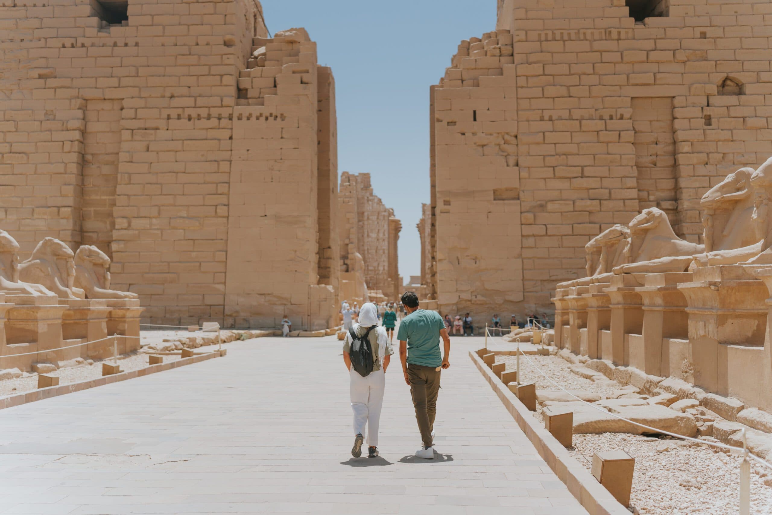 Travelers exploring an ancient temple in Luxor with a local guide